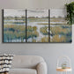 Three-panel canvas wall art featuring pastoral marshland landscape, displayed in a modern living room above a sofa.
