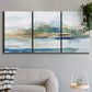 Three-panel canvas wall art featuring flowing blue abstract watercolor, displayed in a modern living room above a sofa.