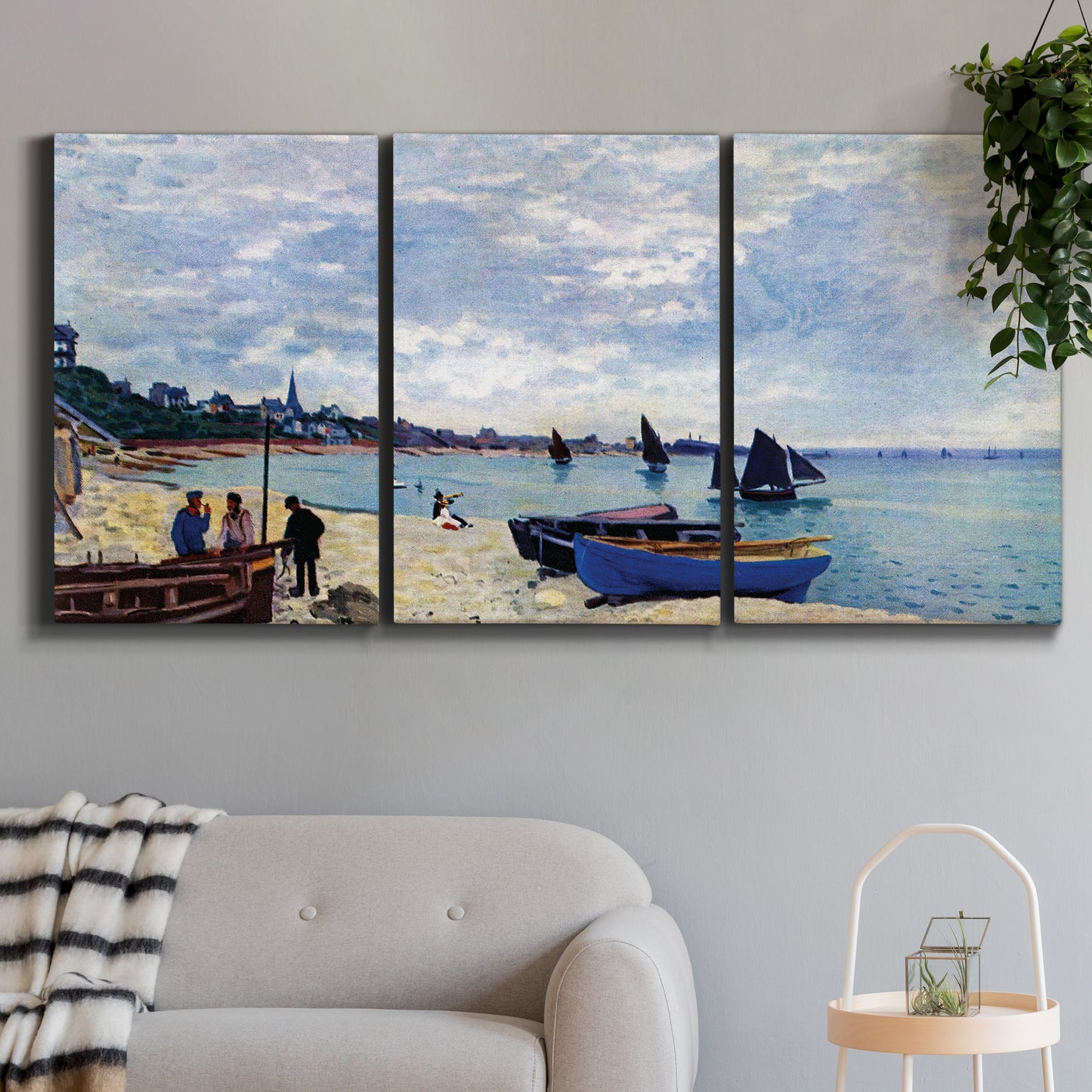 Three-panel canvas wall art featuring busy beach scene with shoreline, displayed in a modern living room above a sofa.