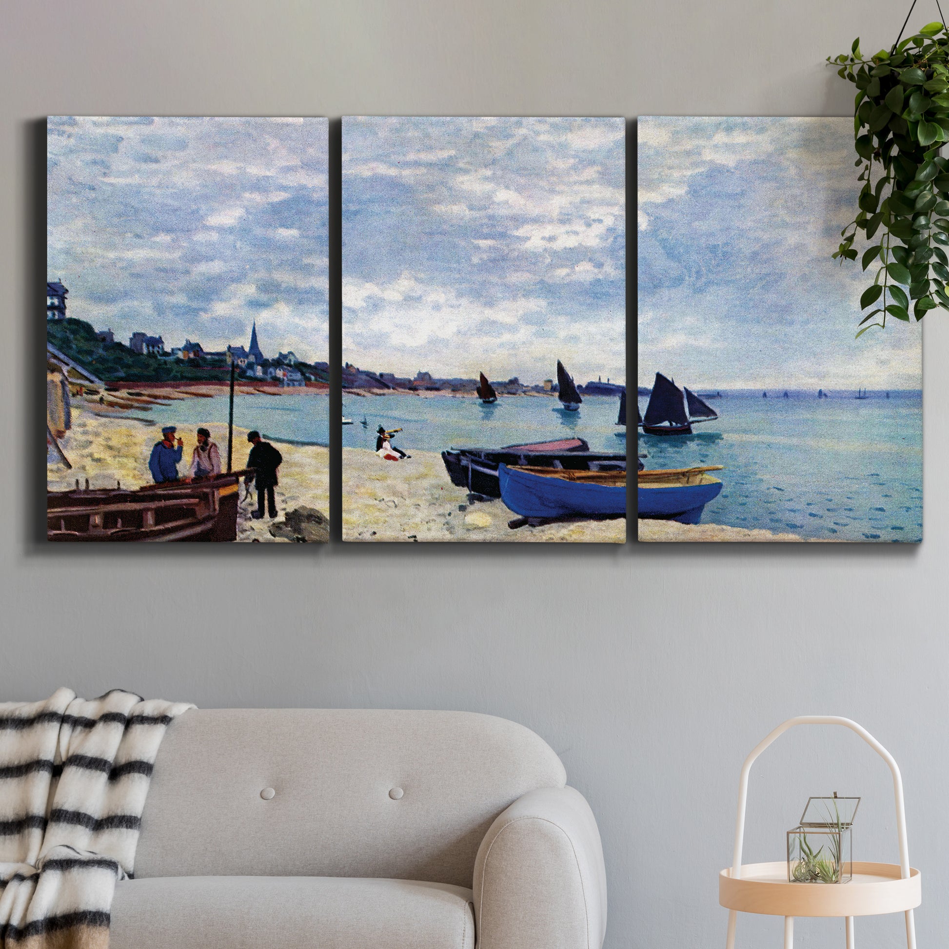 Three-panel canvas wall art featuring busy beach scene with shoreline, displayed in a modern living room above a sofa.