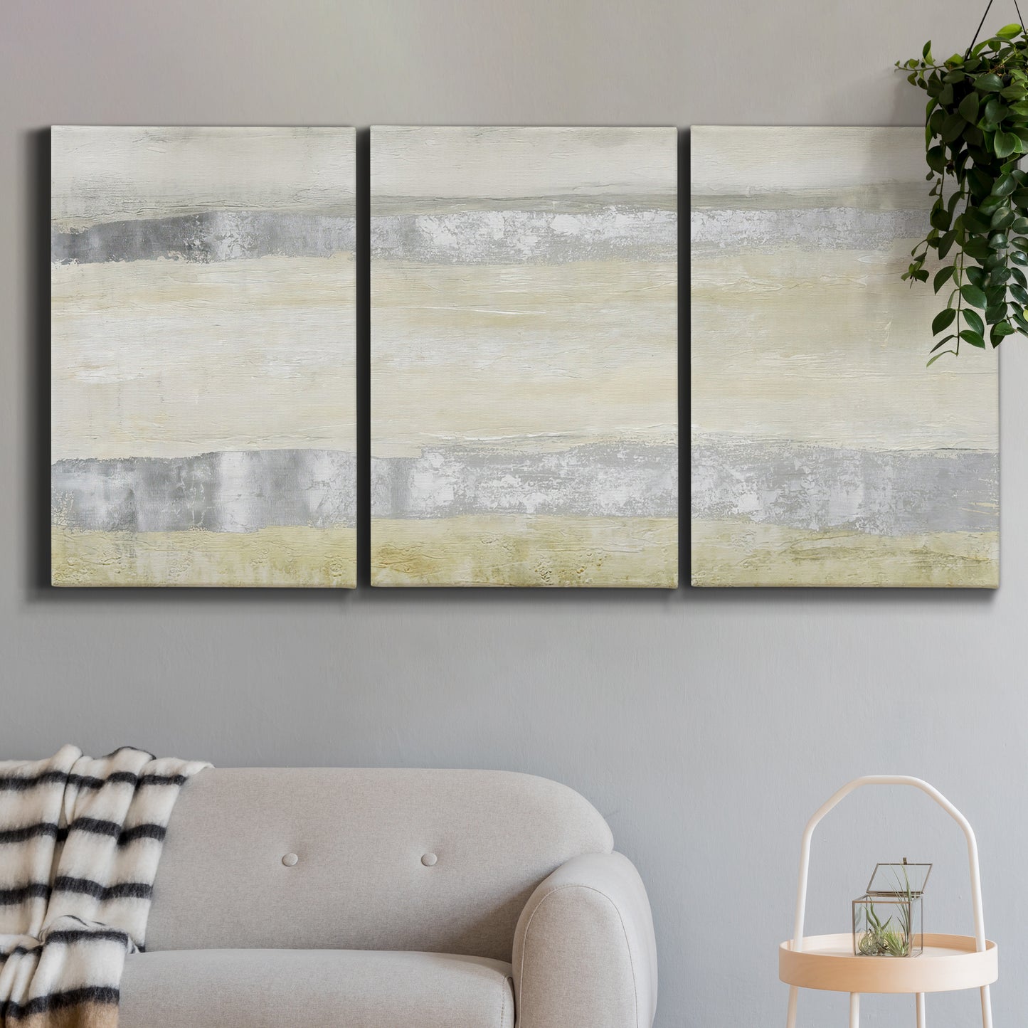 Three-panel canvas wall art featuring minimal abstract storm movement, displayed in a modern living room above a sofa.
