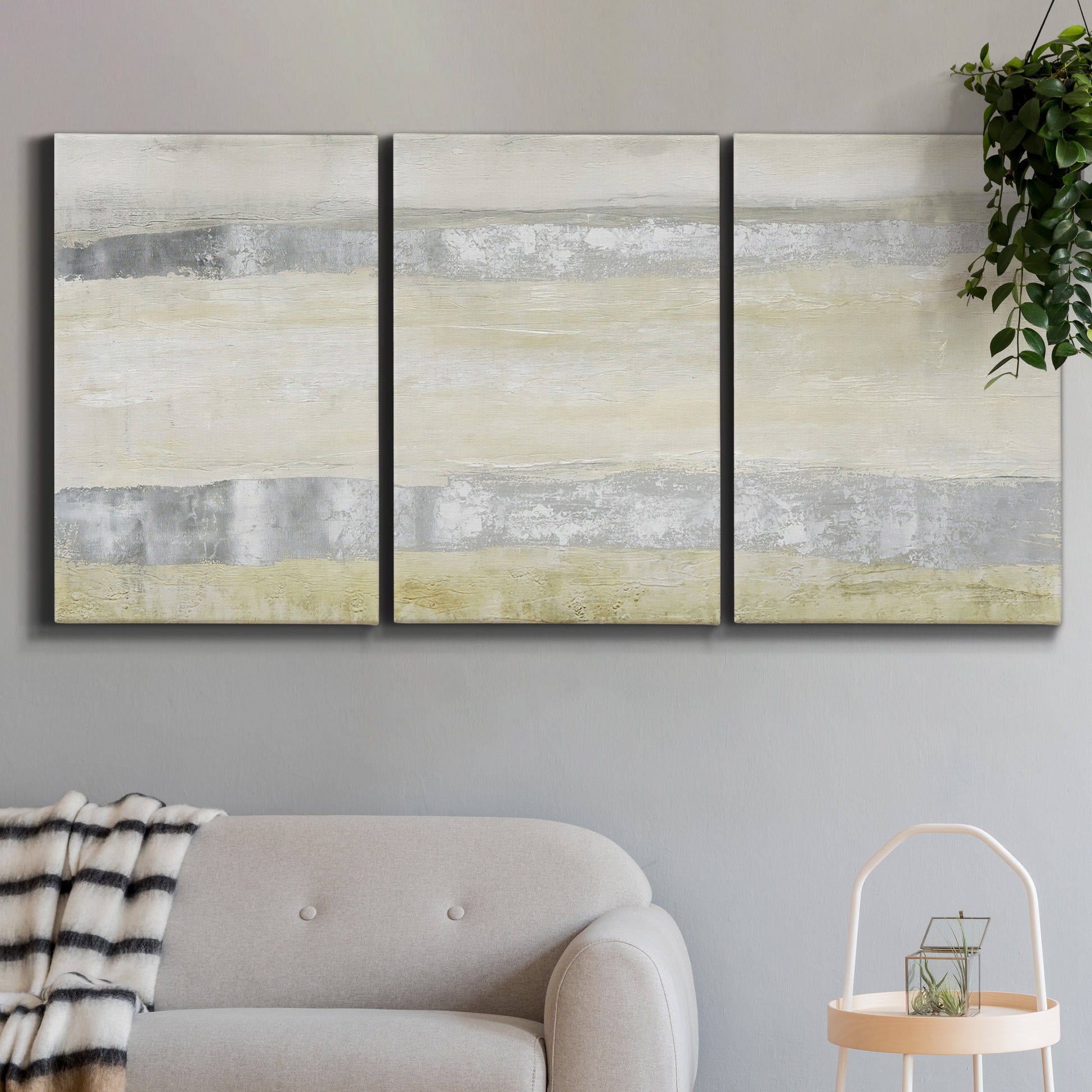 Three-panel canvas wall art featuring minimal abstract storm movement, displayed in a modern living room above a sofa.
