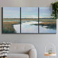 Three-panel canvas wall art featuring coastal plain meeting open water, displayed in a modern living room above a sofa.