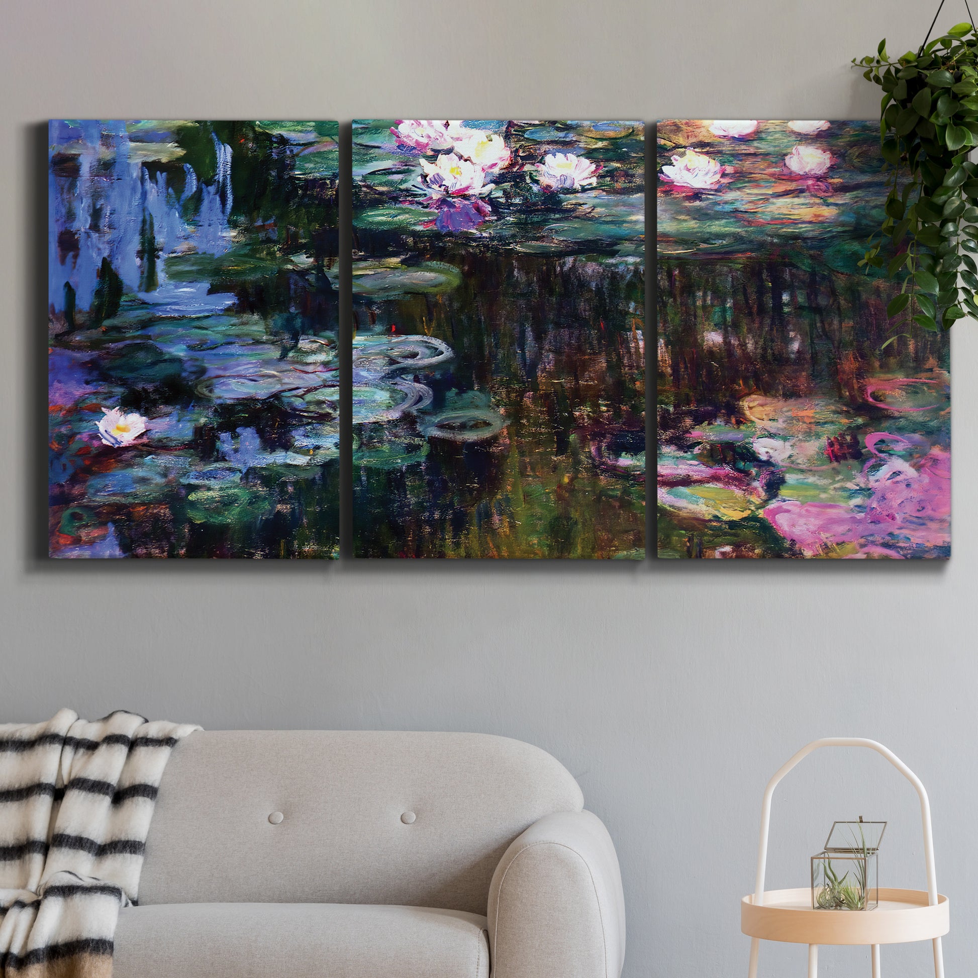 Three-panel canvas wall art featuring water lilies with willow reflections, displayed in a modern living room above a sofa.