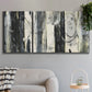 Three-panel canvas wall art featuring vertical abstract tree forms, displayed in a modern living room above a sofa.