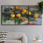 Three-panel canvas wall art featuring still life with pears and grapes, displayed in a modern living room above a sofa.