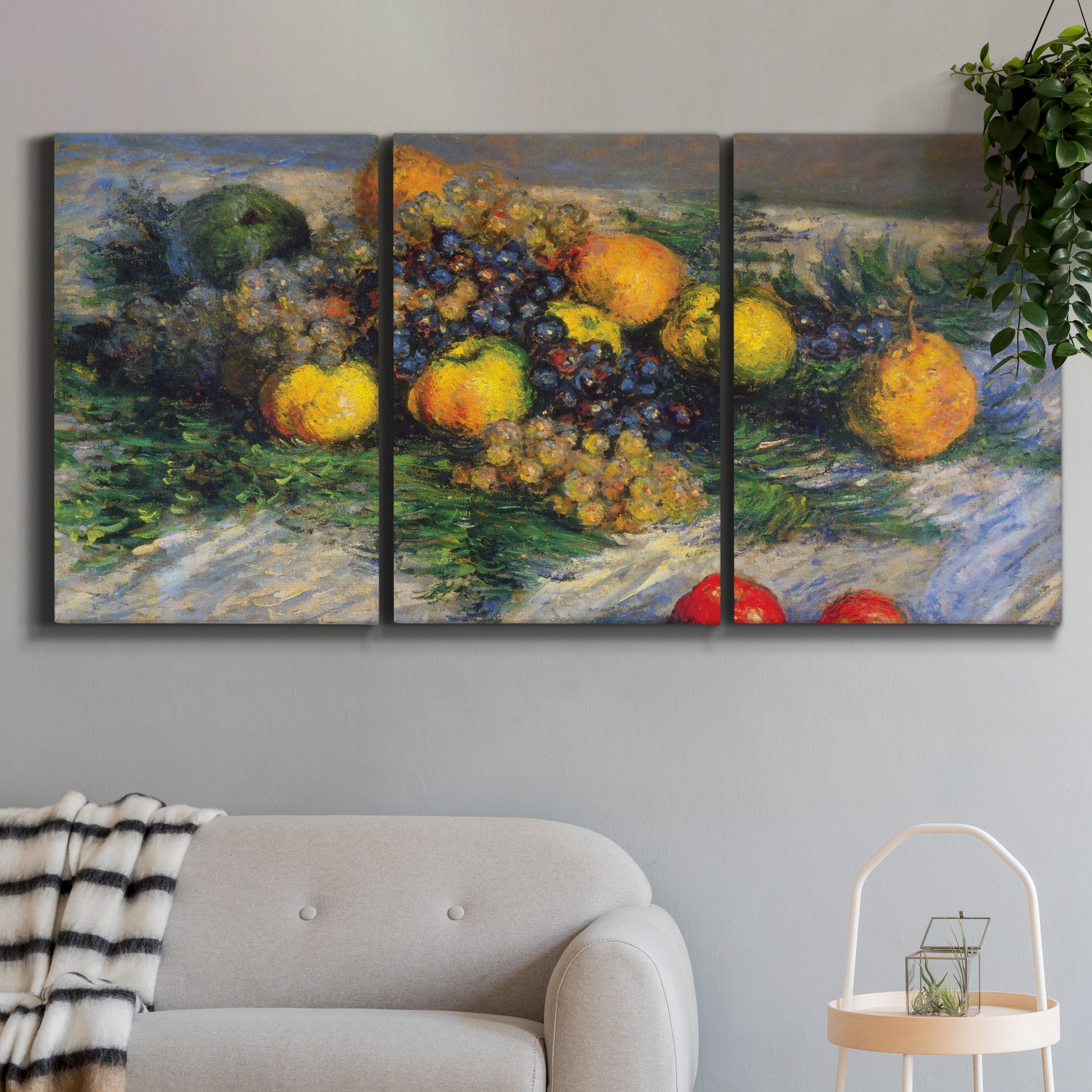 Three-panel canvas wall art featuring still life with pears and grapes, displayed in a modern living room above a sofa.