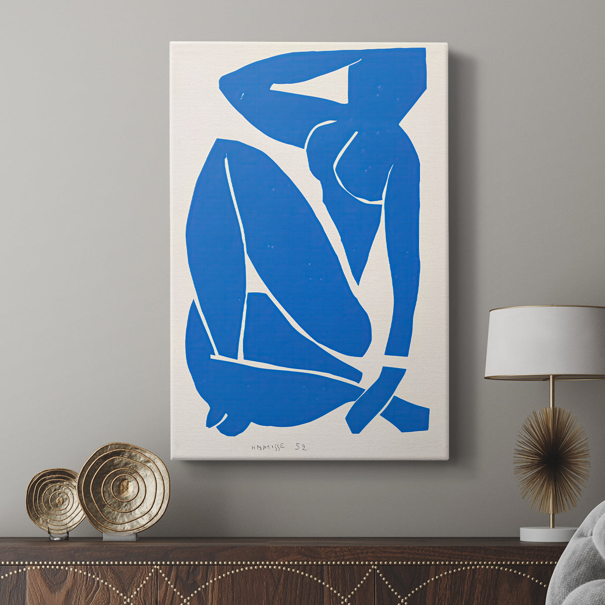 Canvas art print featuring a modern figure built from geometric cut-out shapes displayed in a modern interior space.
