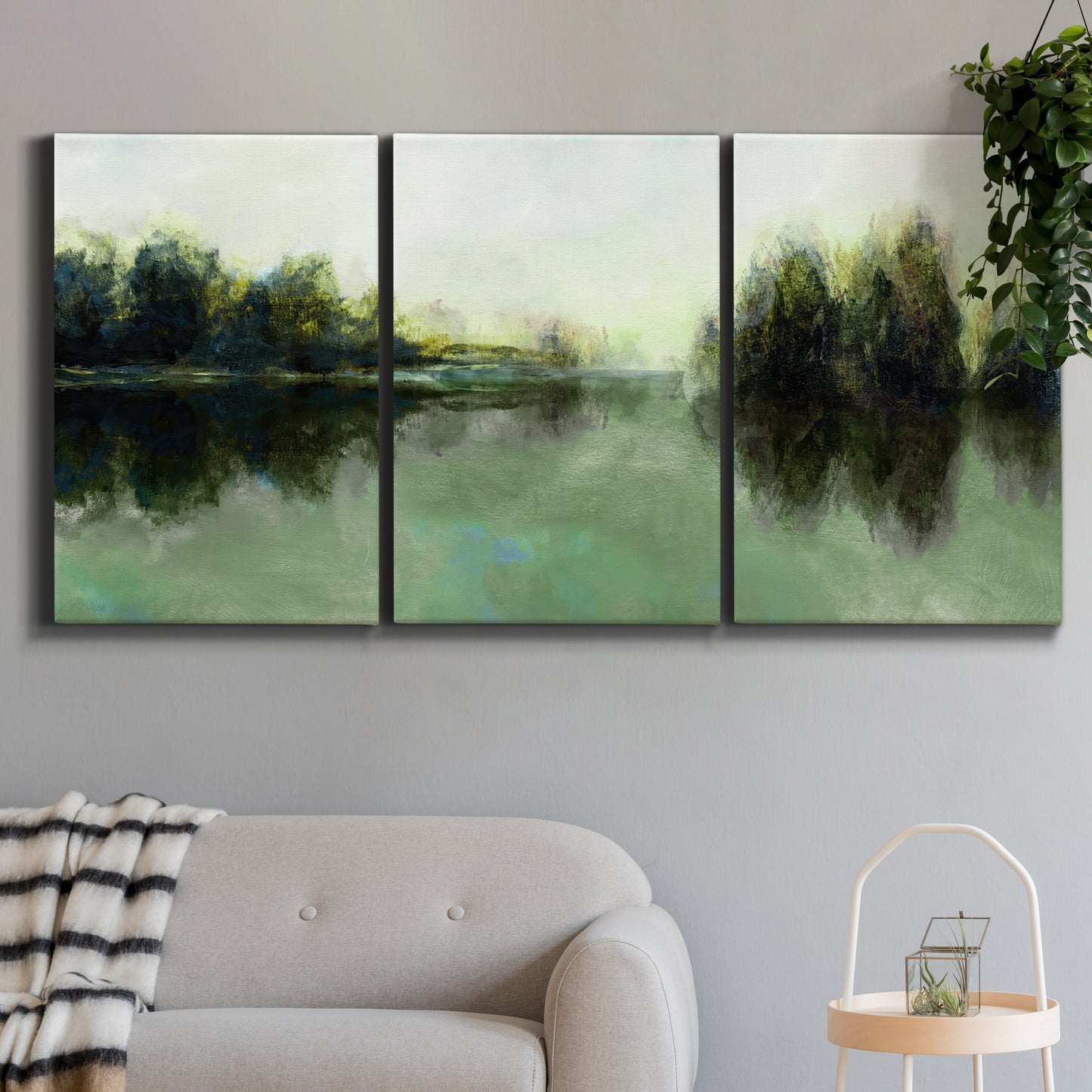 Three-panel canvas wall art featuring rain soaked landscape at sunset, displayed in a modern living room above a sofa.