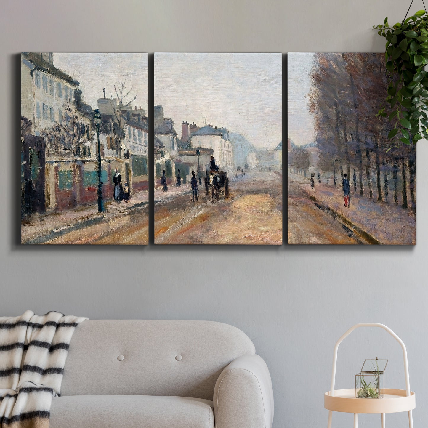 Three-panel canvas wall art featuring tree lined boulevard in town, displayed in a modern living room above a sofa.
