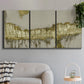 Three-panel canvas wall art featuring gold accented abstract ravine, displayed in a modern living room above a sofa.