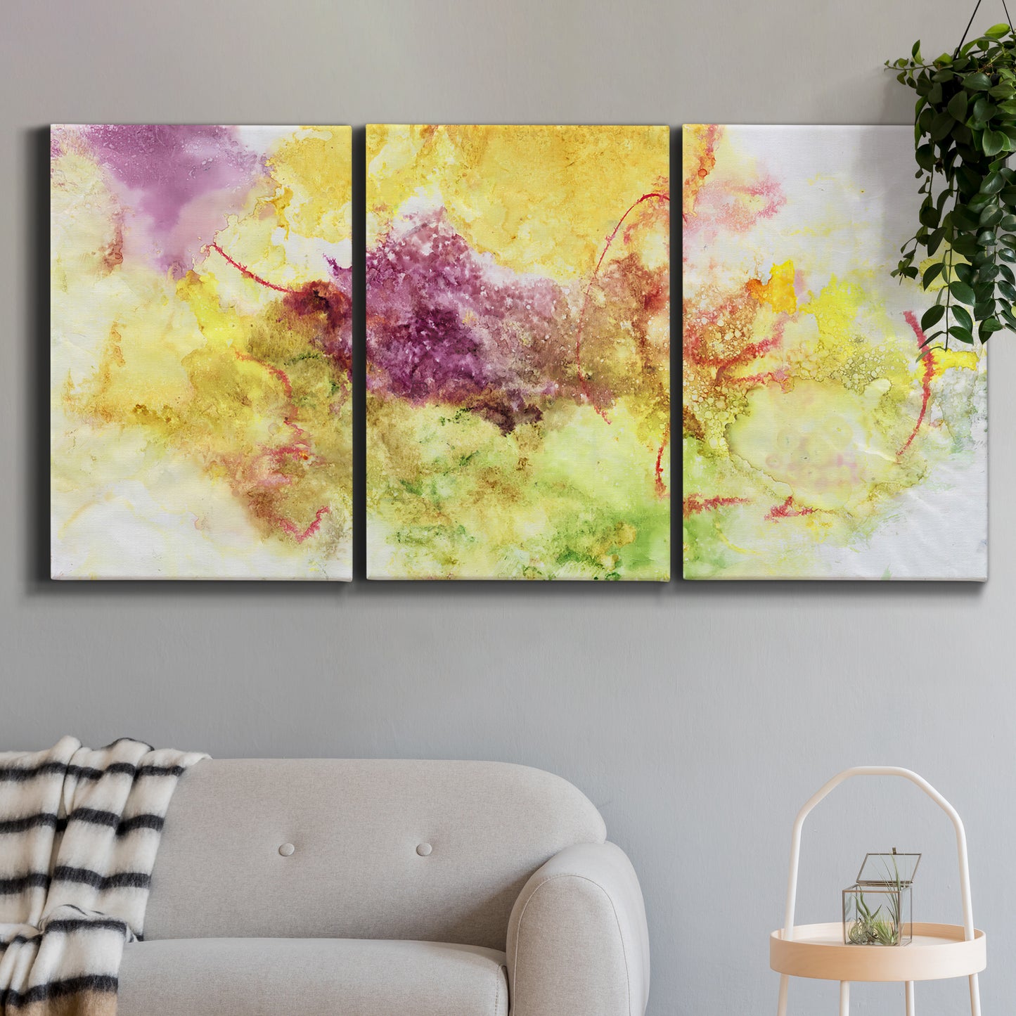 Three-panel canvas wall art featuring abstract floral rhythm composition, displayed in a modern living room above a sofa.