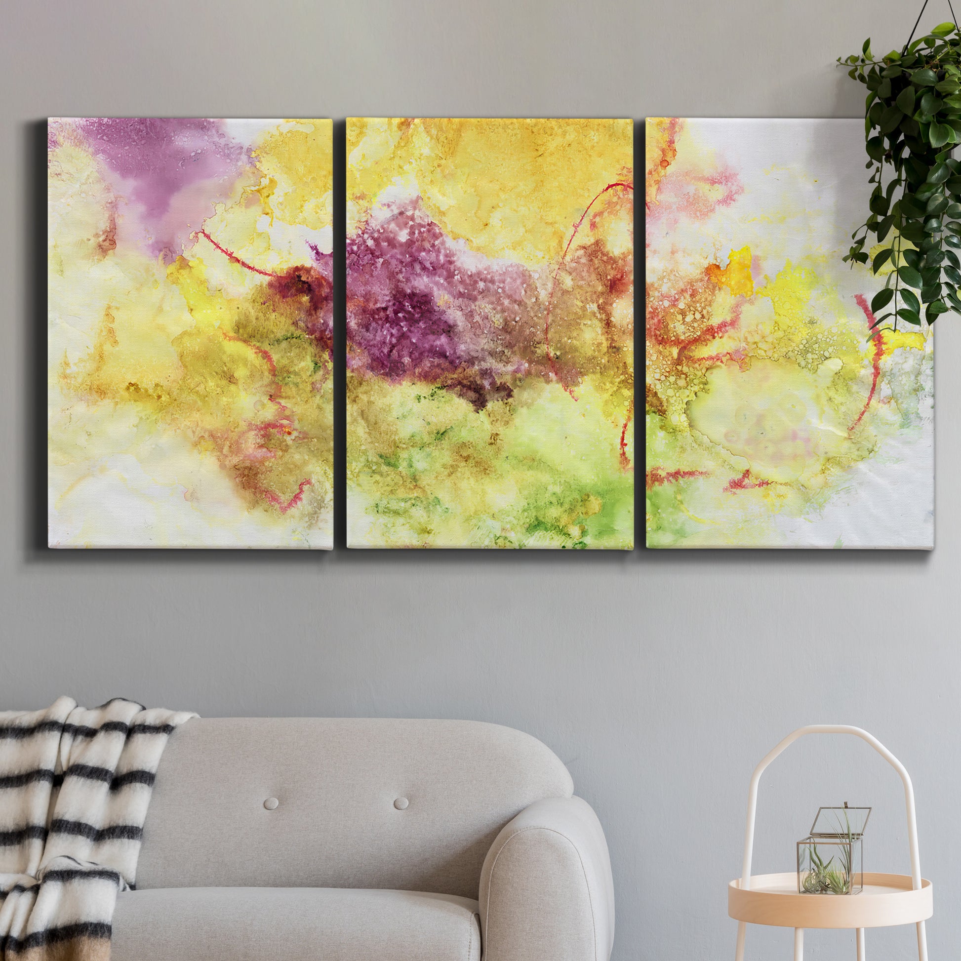 Three-panel canvas wall art featuring abstract floral rhythm composition, displayed in a modern living room above a sofa.