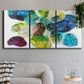 Three-panel canvas wall art featuring expressive abstract color interpretations, displayed in a modern living room above a sofa.
