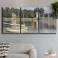 Three-panel canvas wall art featuring bridge crossing broad river, displayed in a modern living room above a sofa.