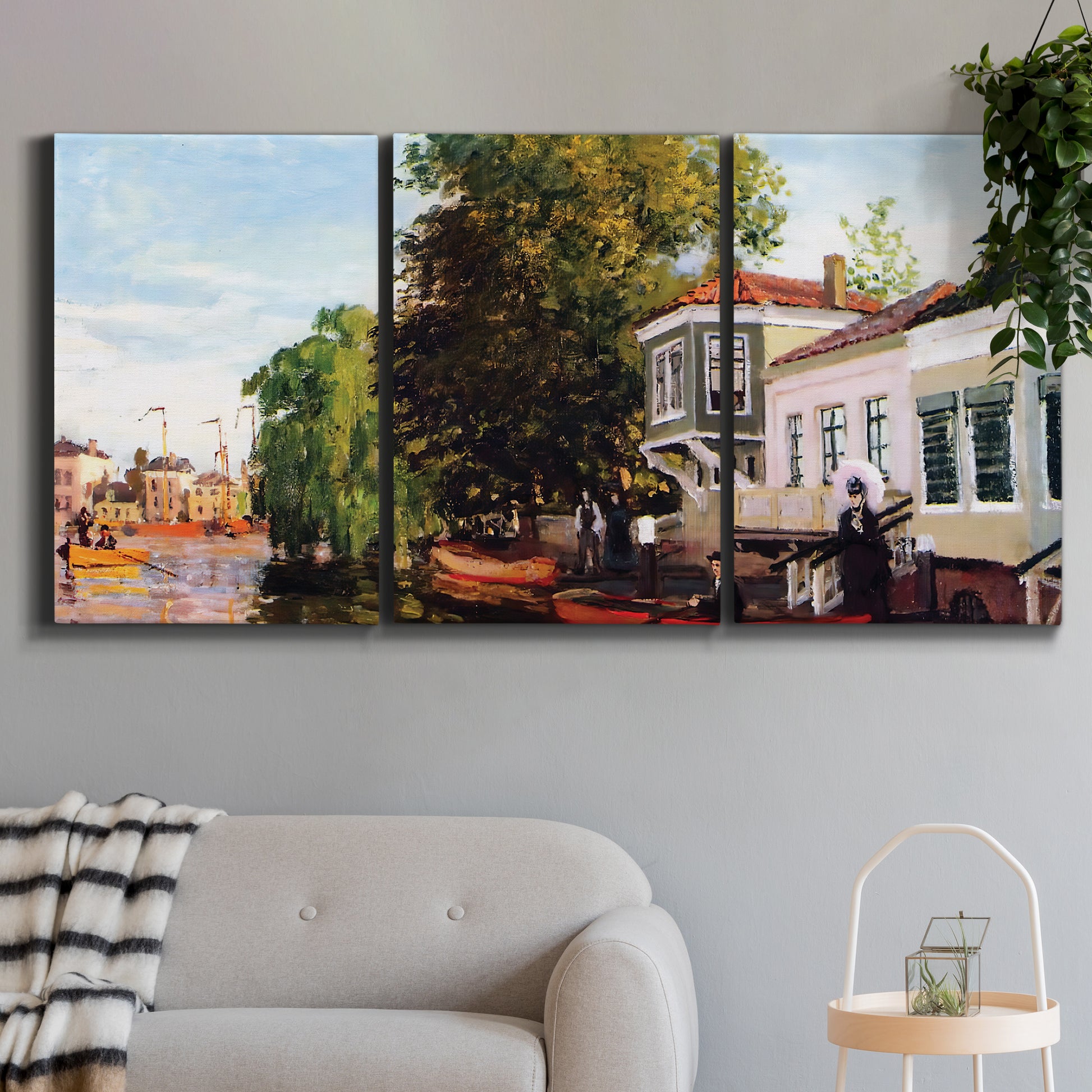 Three-panel canvas wall art featuring riverside houses along canal, displayed in a modern living room above a sofa.