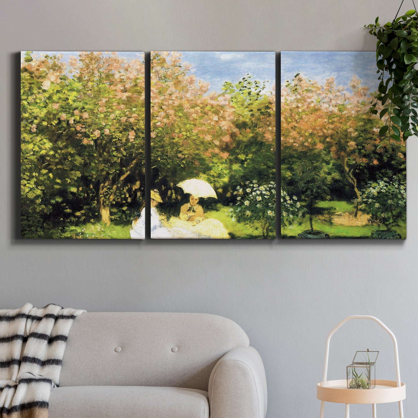 Three-panel canvas wall art featuring lush garden landscape with trees, displayed in a modern living room above a sofa.