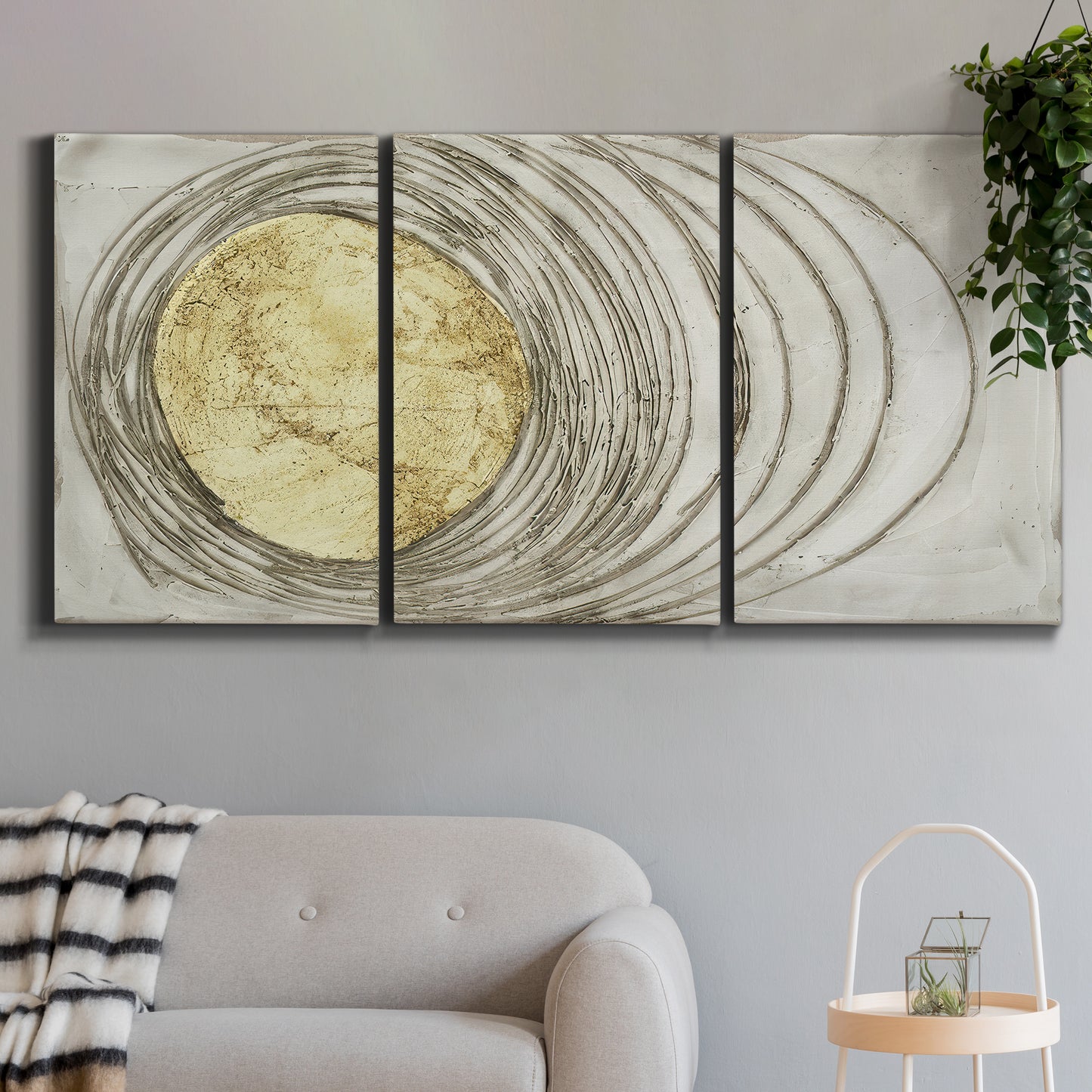 Three-panel canvas wall art featuring circular abstract energy forms, displayed in a modern living room above a sofa.