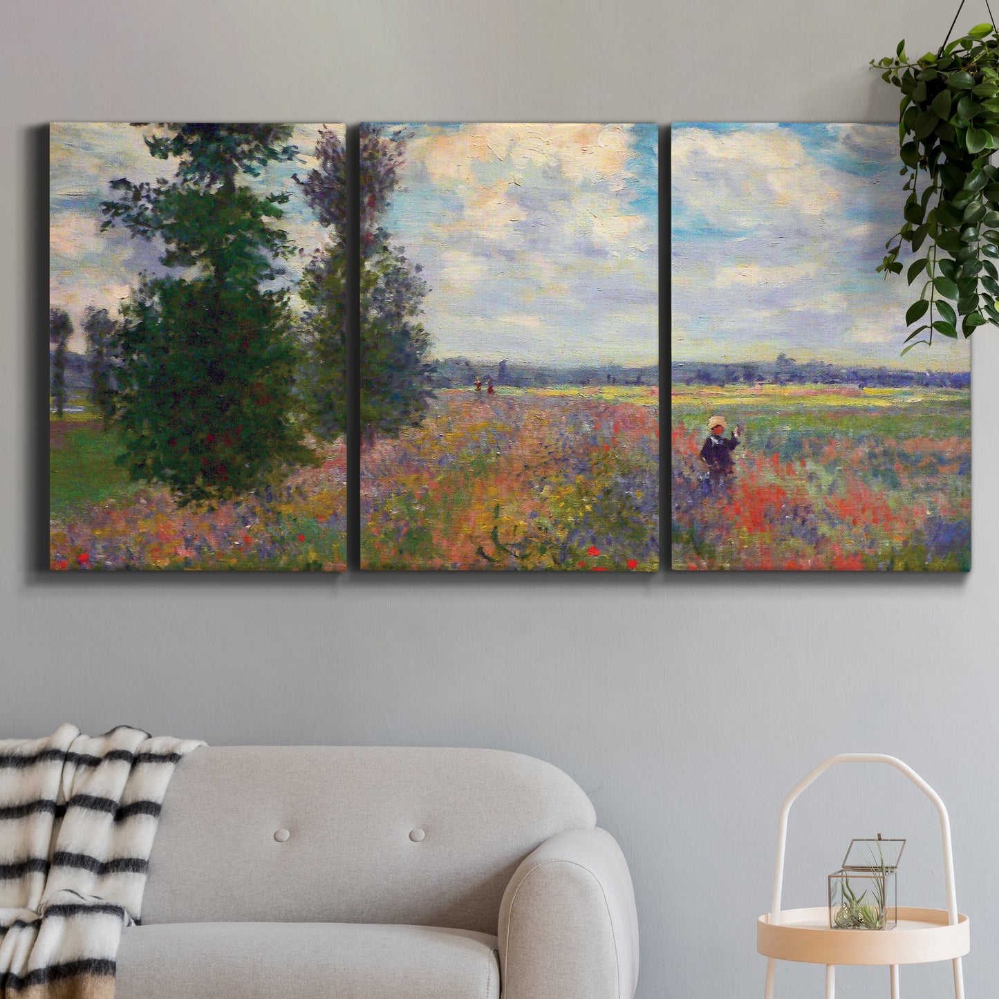 Three-panel canvas wall art featuring poppy field in open countryside, displayed in a modern living room above a sofa.