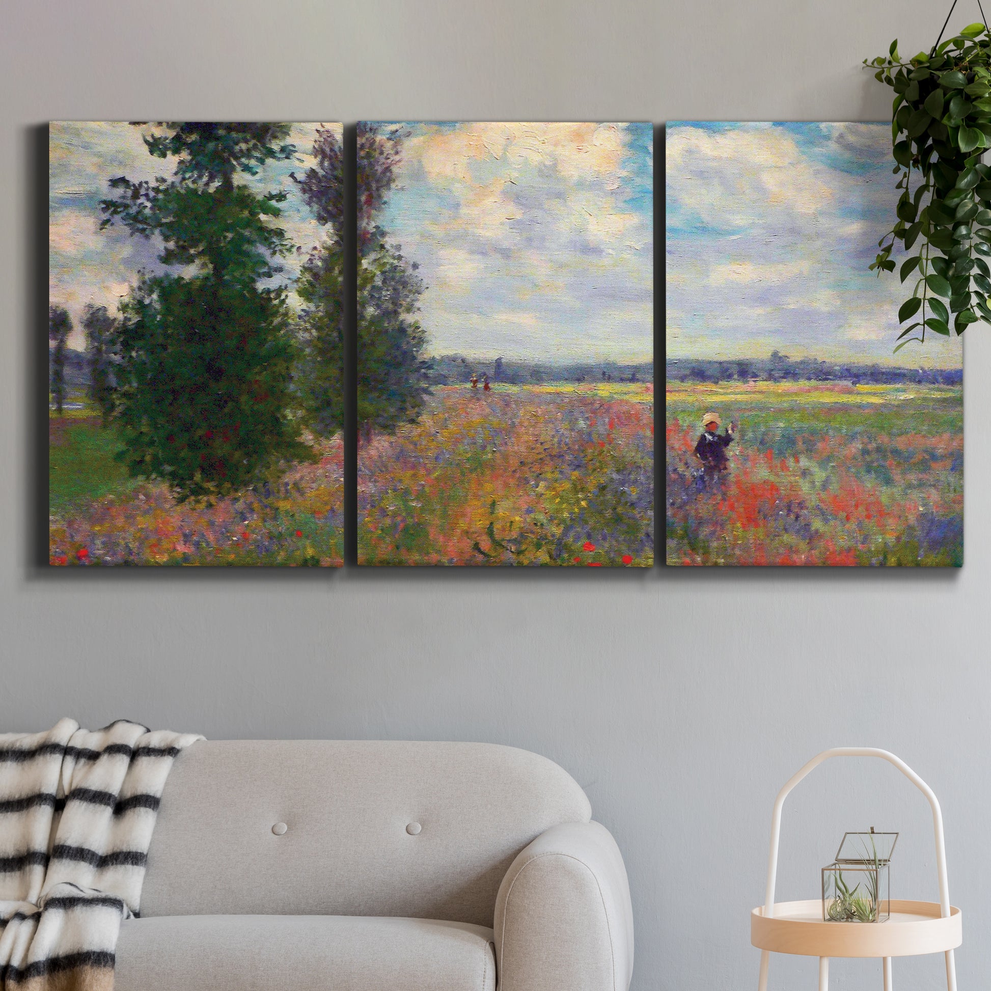 Three-panel canvas wall art featuring poppy field in open countryside, displayed in a modern living room above a sofa.