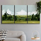 Three-panel canvas wall art featuring lush green summer countryside, displayed in a modern living room above a sofa.