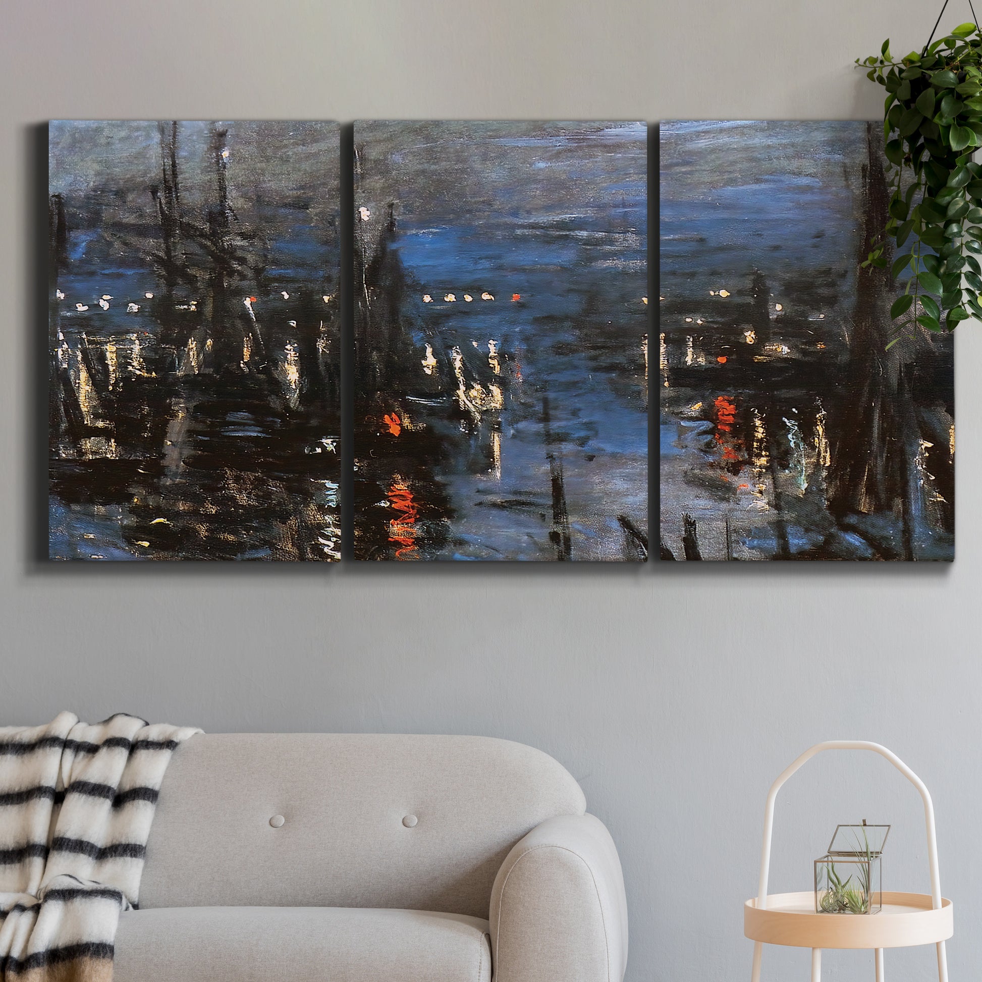 Three-panel canvas wall art featuring Le Havre port at night with lights, displayed in a modern living room above a sofa.