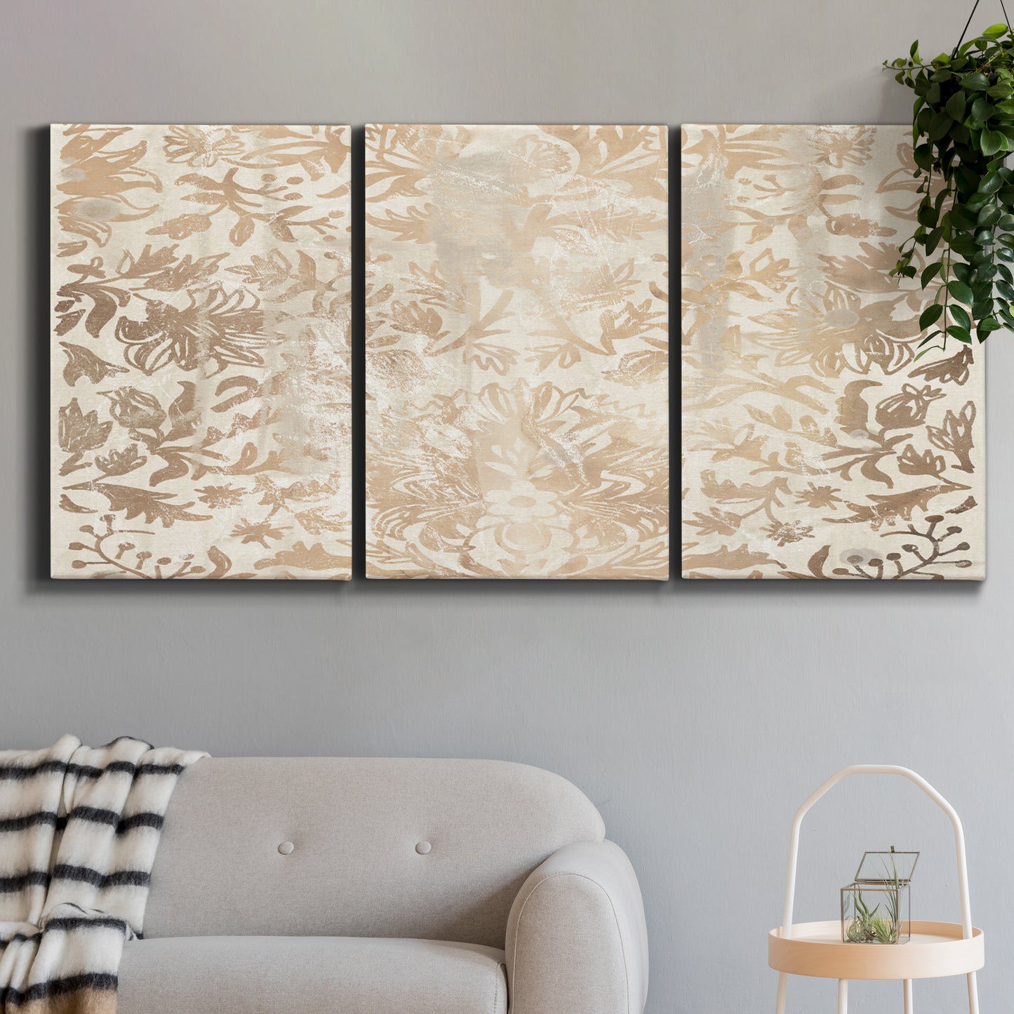Three-panel canvas wall art featuring ornamental damask abstract pattern, displayed in a modern living room above a sofa.