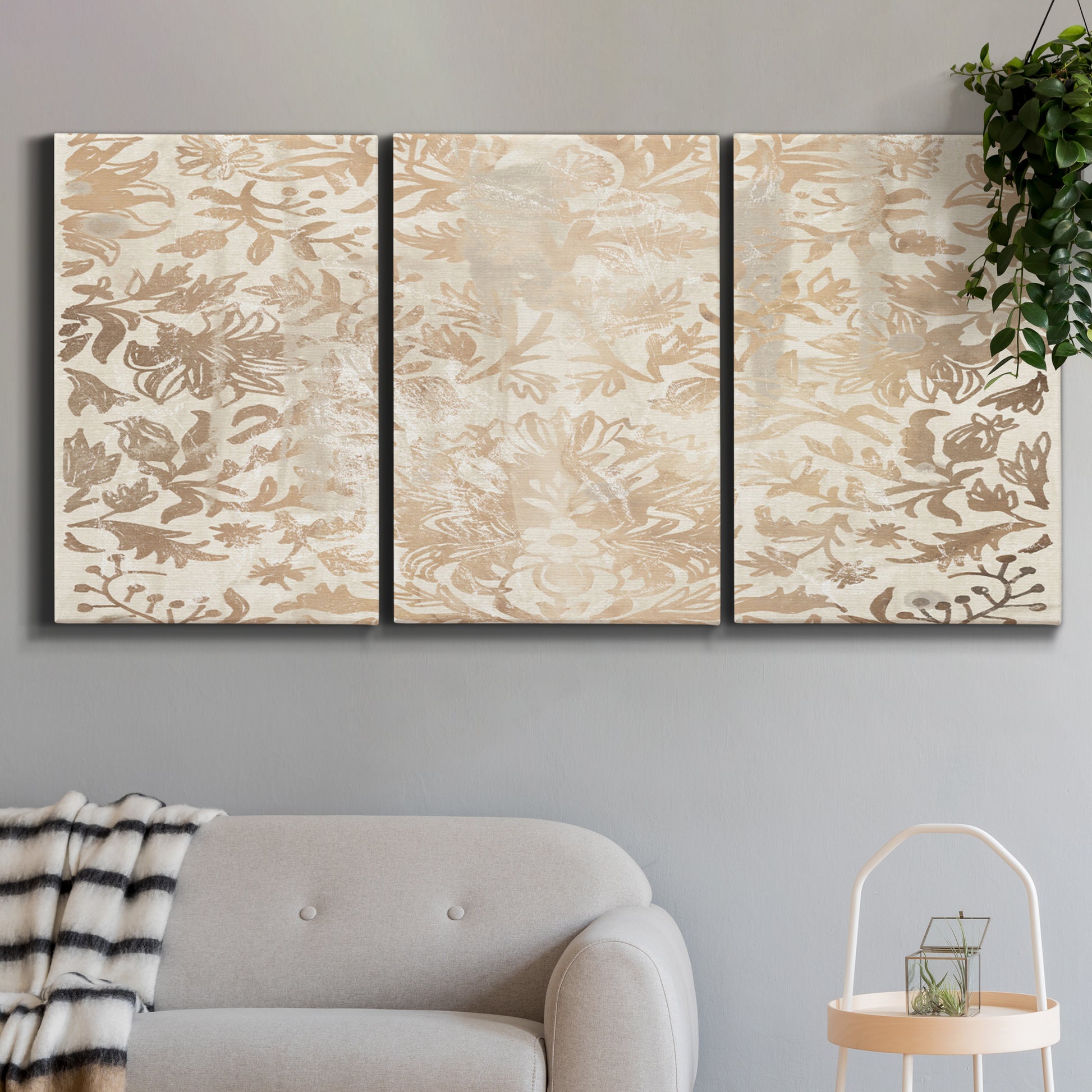 Three-panel canvas wall art featuring ornamental damask abstract pattern, displayed in a modern living room above a sofa.