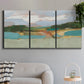 Three-panel canvas wall art featuring wide open landscape under midday light, displayed in a modern living room above a sofa.