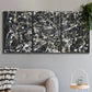 Three-panel canvas wall art featuring energetic expressionist abstract splatter, displayed in a modern living room above a sofa.