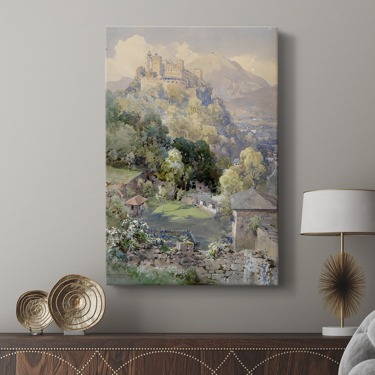Canvas art print featuring a historic fortress set within a mountainous landscape displayed in a modern interior space.