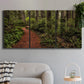 Three-panel canvas wall art featuring forest trail landscape photograph, displayed in a modern living room above a sofa.