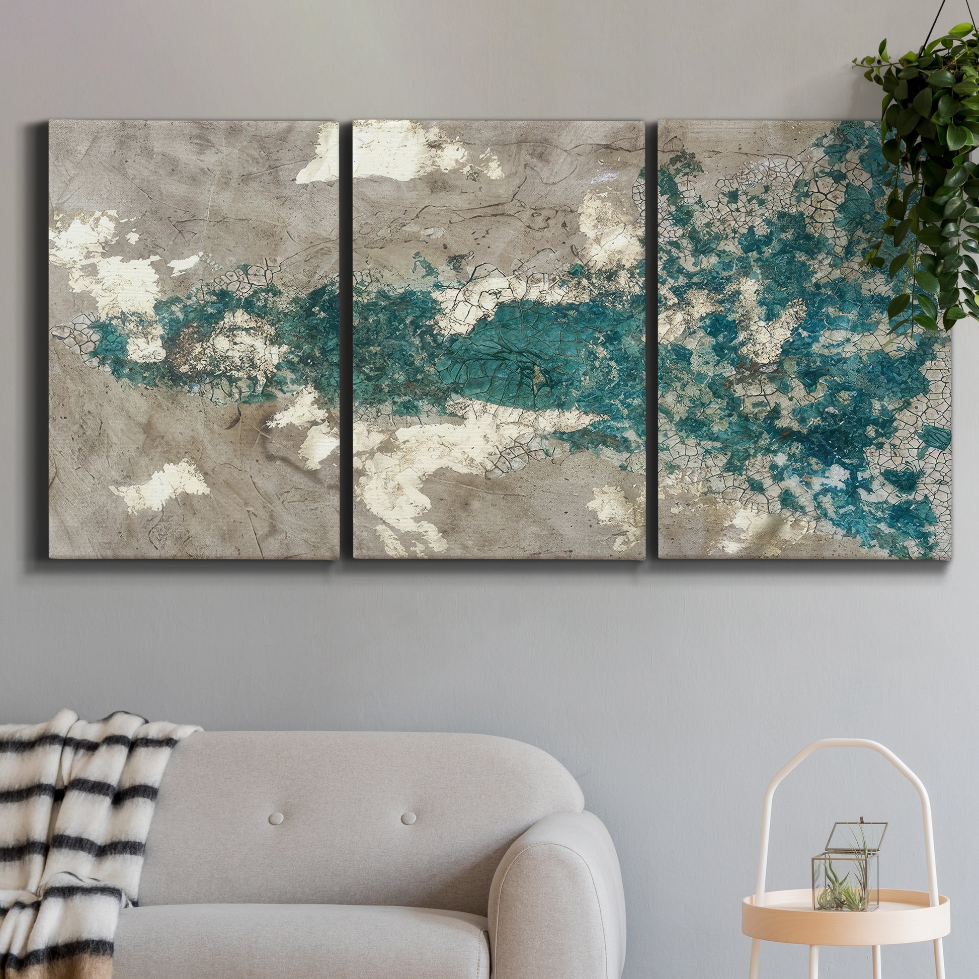 Three-panel canvas wall art featuring layered mineral abstract textures, displayed in a modern living room above a sofa.