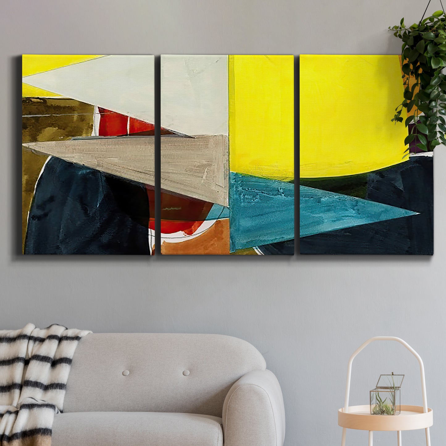 Three-panel canvas wall art featuring geometric mid century abstract blocks, displayed in a modern living room above a sofa.