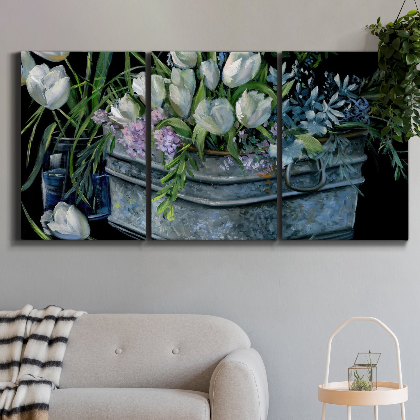 Three-panel canvas wall art featuring colorful wild tulips in bloom, displayed in a modern living room above a sofa.