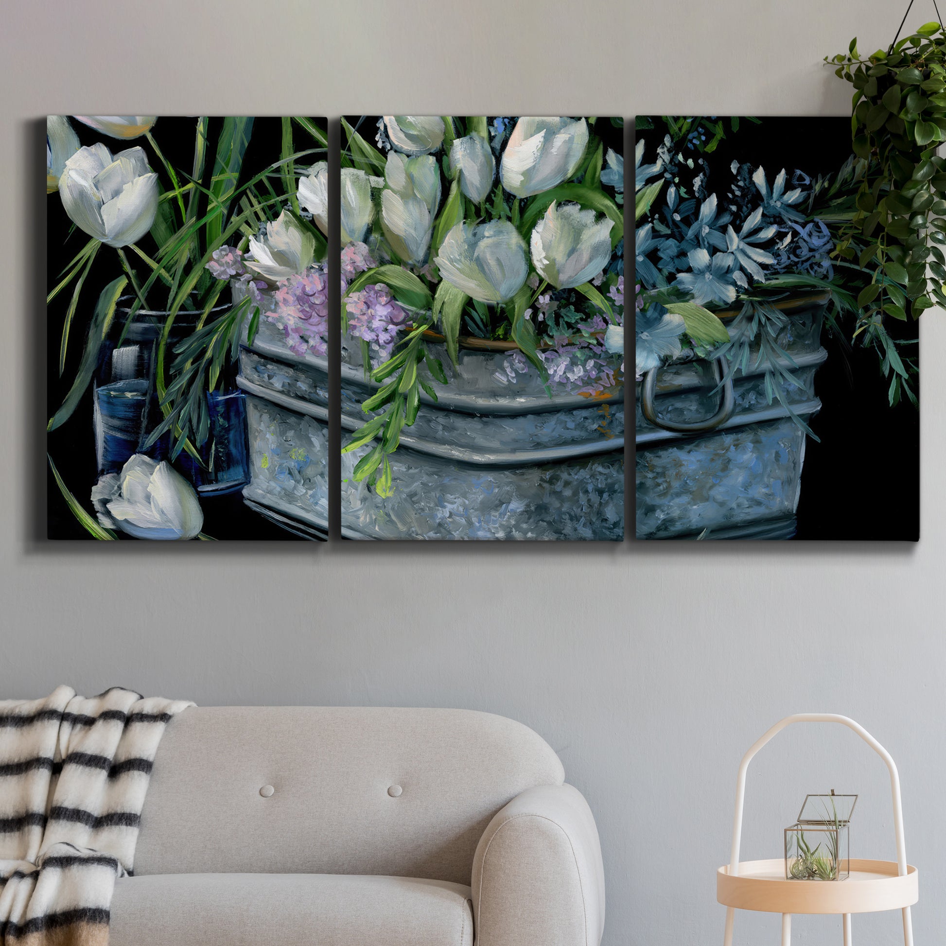 Three-panel canvas wall art featuring colorful wild tulips in bloom, displayed in a modern living room above a sofa.