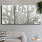 Three-panel canvas wall art featuring monochrome coral texture study, displayed in a modern living room above a sofa.
