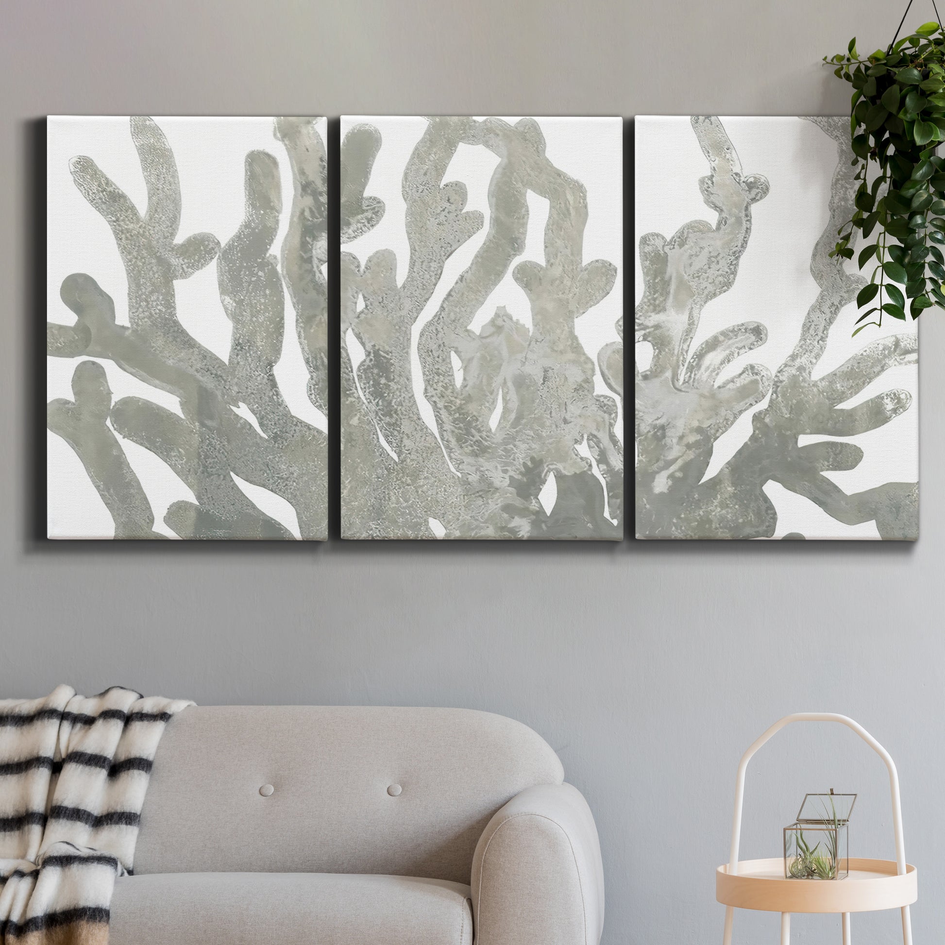 Three-panel canvas wall art featuring monochrome coral texture study, displayed in a modern living room above a sofa.