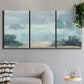 Three-panel canvas wall art featuring soft pastel valley landscape, displayed in a modern living room above a sofa.