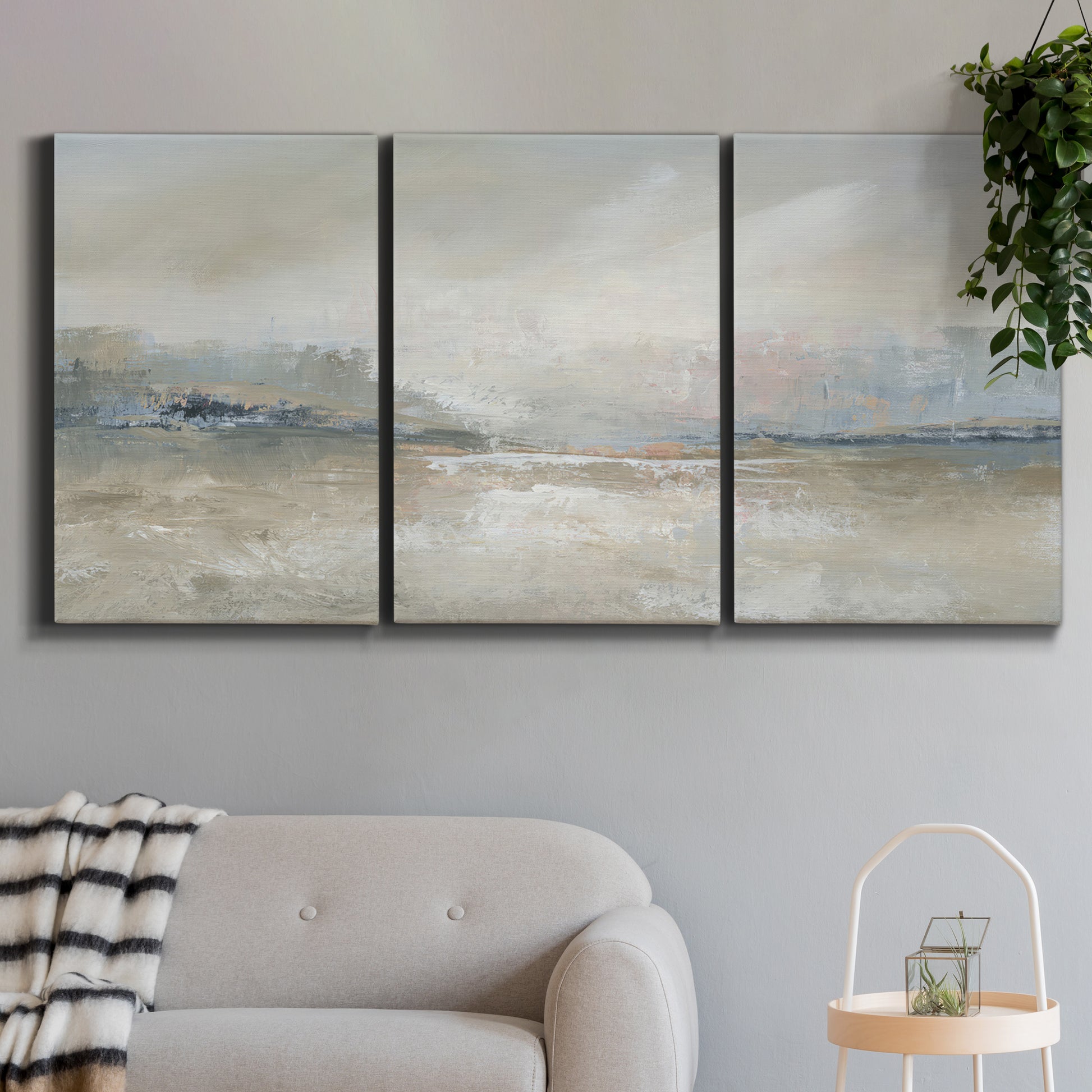 Three-panel canvas wall art featuring soft abstract horizon haze, displayed in a modern living room above a sofa.