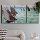 Three-panel canvas wall art featuring sailboat regatta near coastal village, displayed in a modern living room above a sofa.