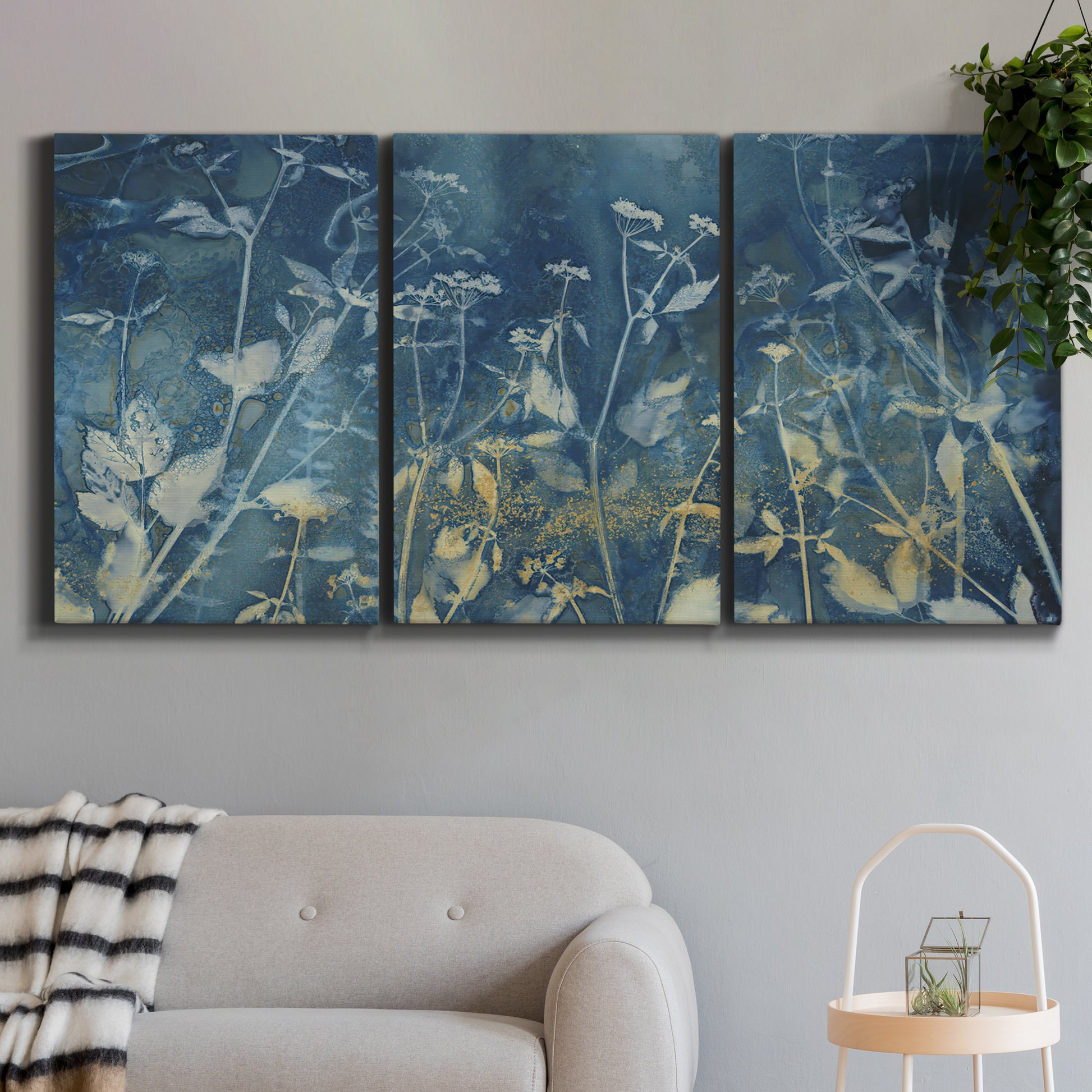 Three-panel canvas wall art featuring dark abstract with rich tonal depth, displayed in a modern living room above a sofa.