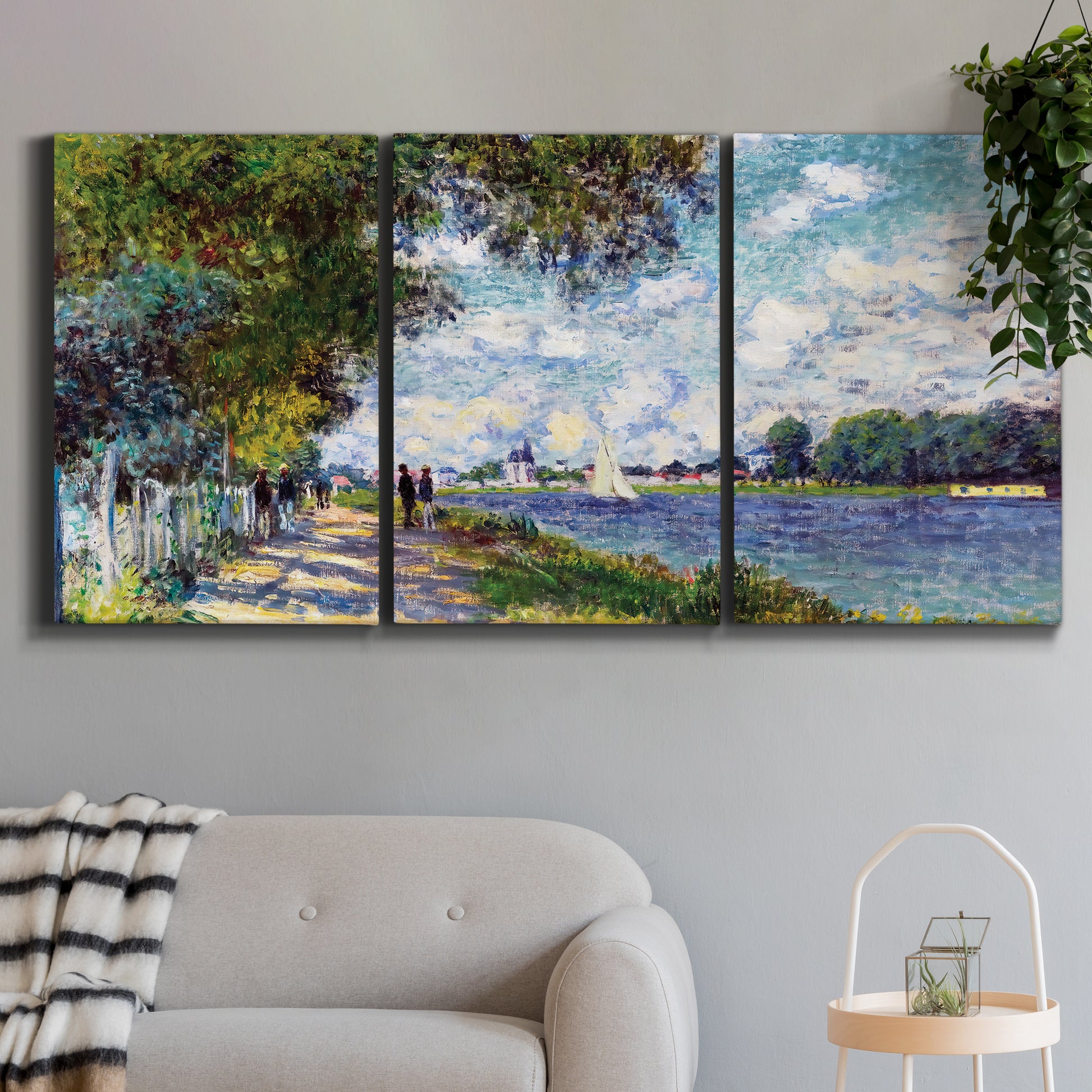 Three-panel canvas wall art featuring river landscape with boats, displayed in a modern living room above a sofa.