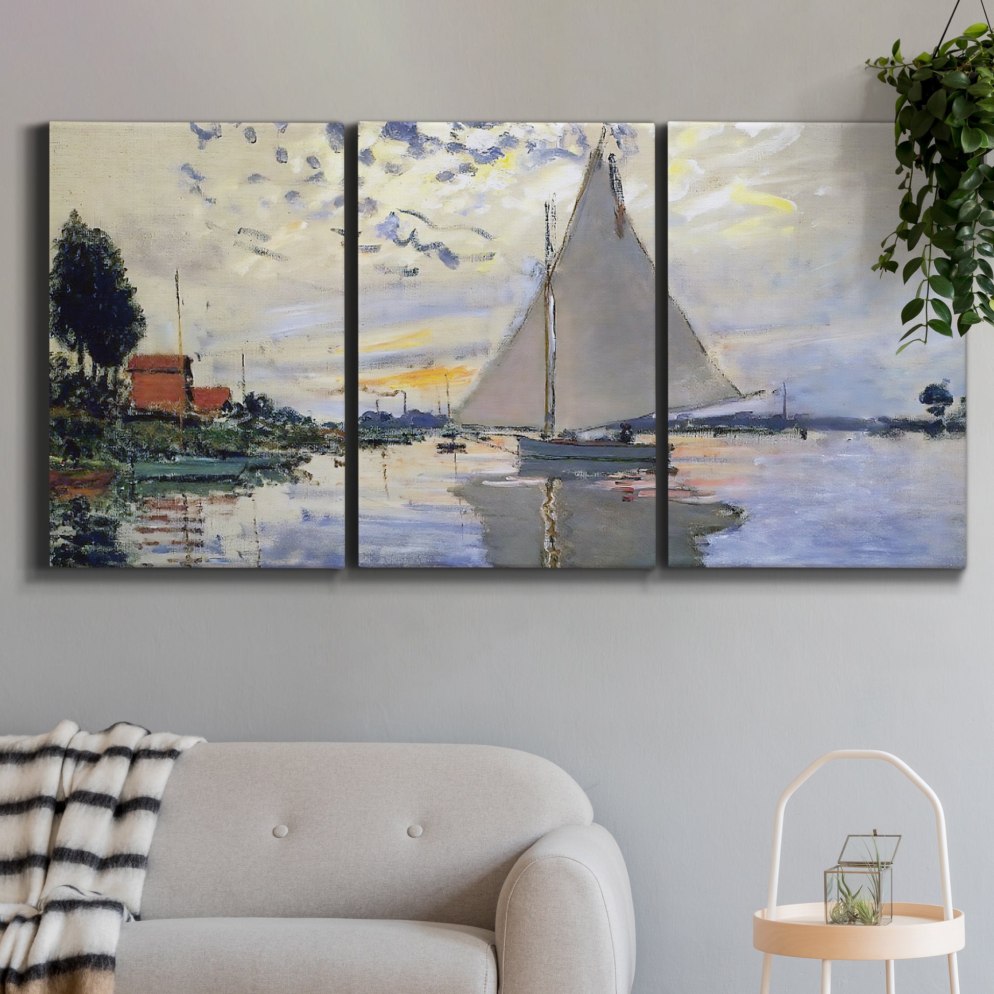 Three-panel canvas wall art featuring riverside village shoreline, displayed in a modern living room above a sofa.