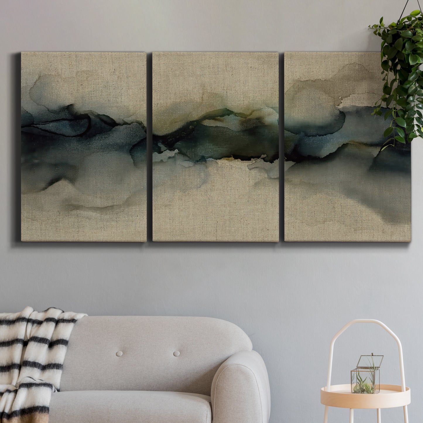 Three-panel canvas wall art featuring calm abstract water surface stillness, displayed in a modern living room above a sofa.