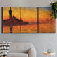 Three-panel canvas wall art featuring Venetian church at sunset, displayed in a modern living room above a sofa.
