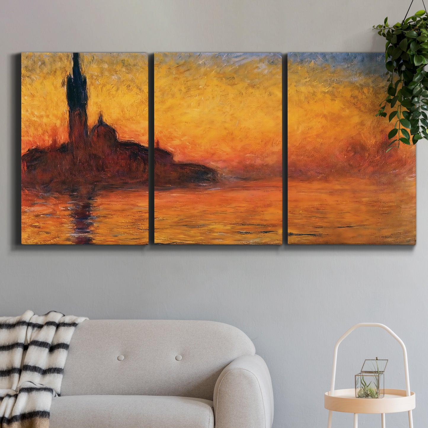 Three-panel canvas wall art featuring Venetian church at sunset, displayed in a modern living room above a sofa.