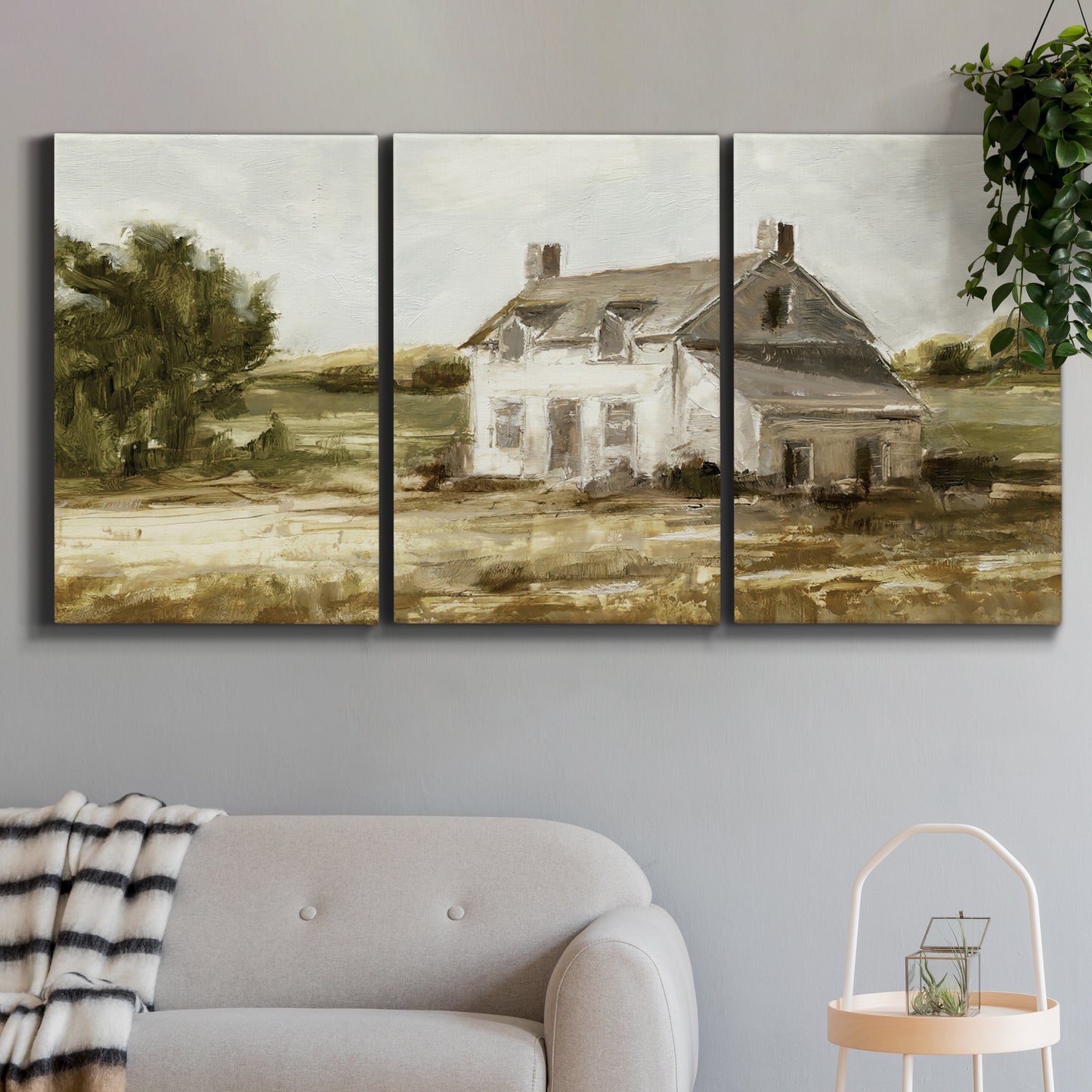Three-panel canvas wall art featuring rural farmhouse harvest landscape, displayed in a modern living room above a sofa.