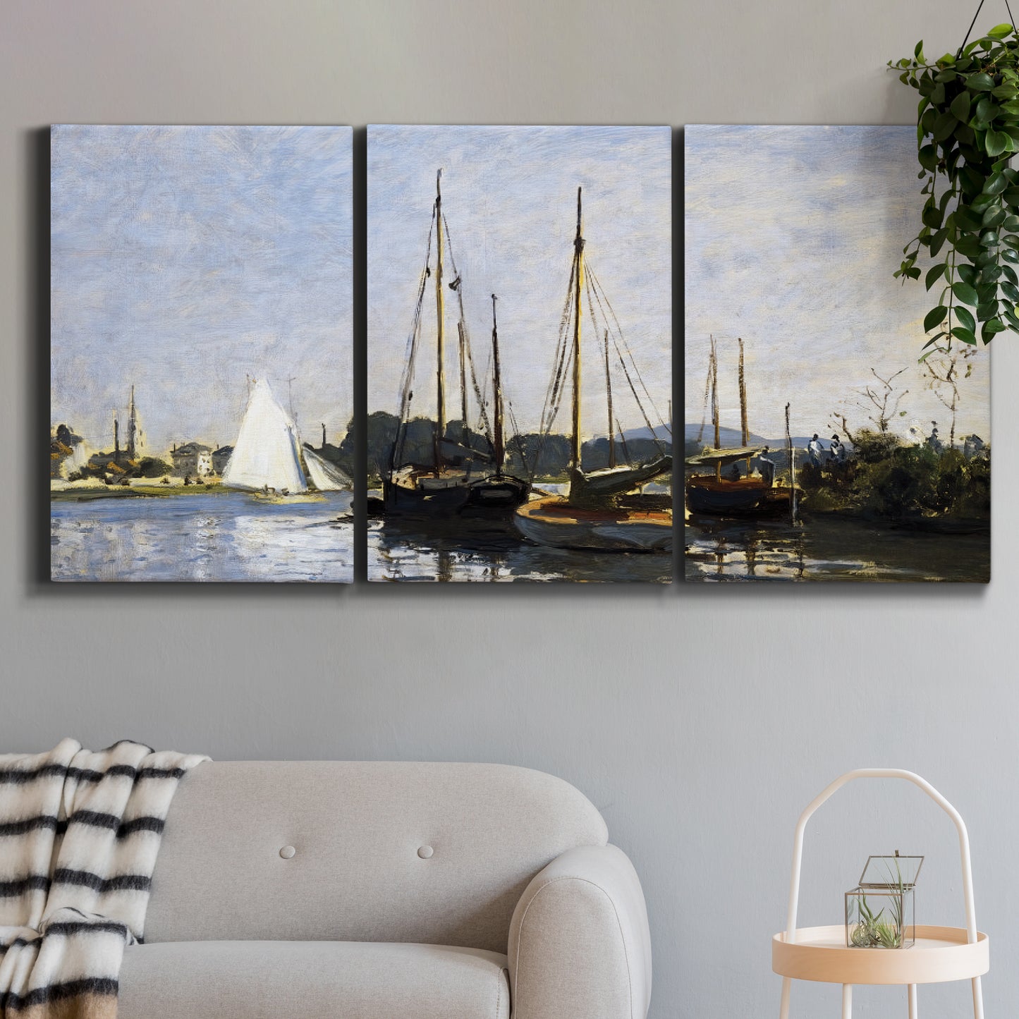 Three-panel canvas wall art featuring small pleasure boats on calm water, displayed in a modern living room above a sofa.
