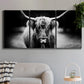 Three-panel canvas wall art featuring black and white cattle portrait, displayed in a modern living room above a sofa.
